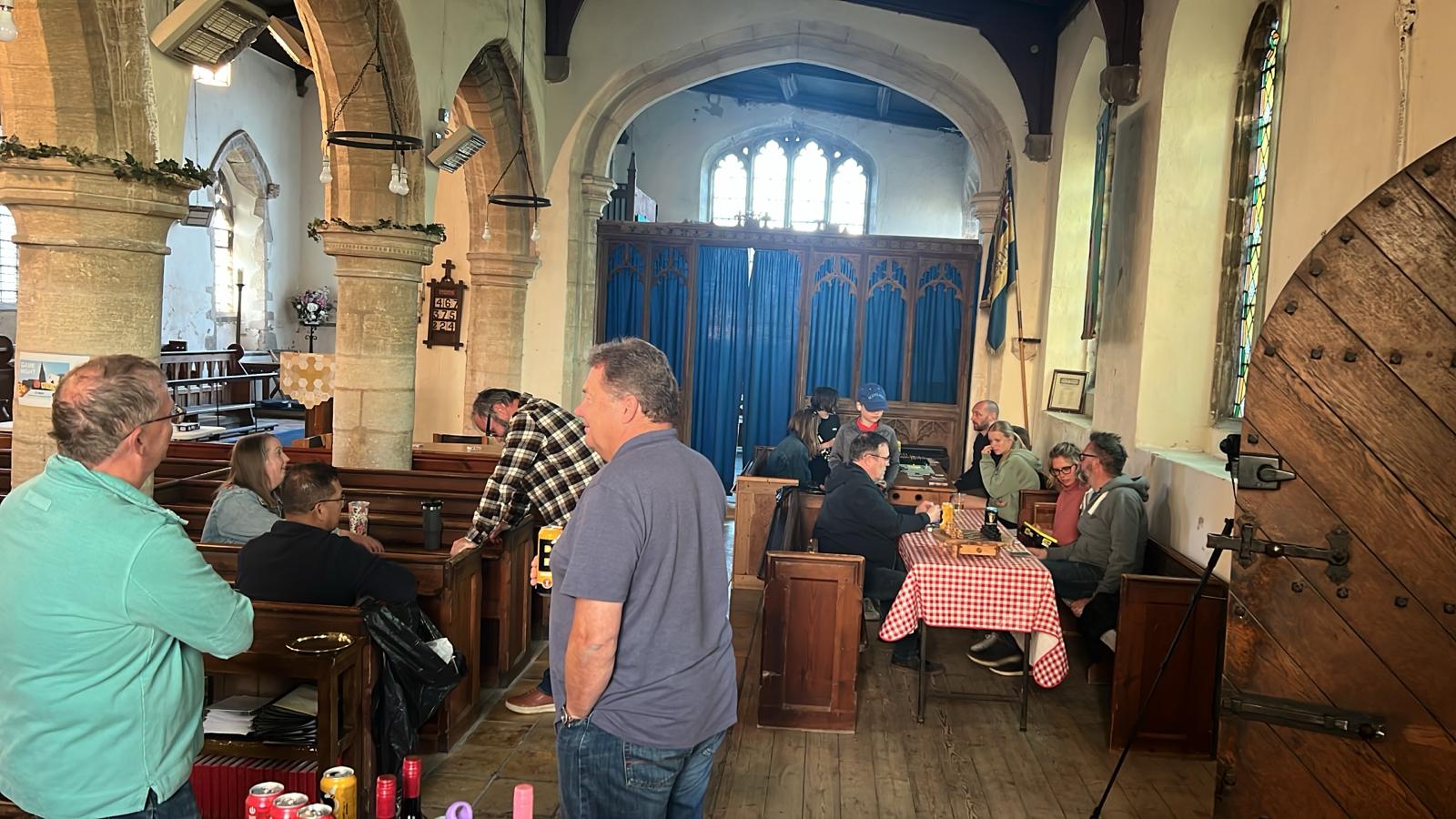 GamesNight1 People sitting at tables in the Church Hall enjoying conversation while playing boardgames